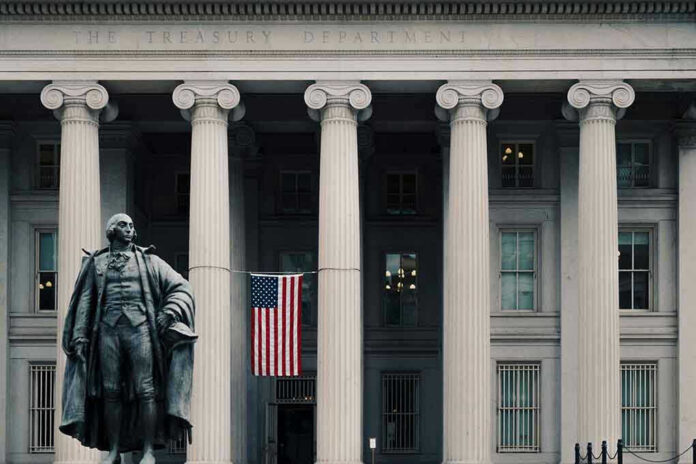 1240657660-2 US Treasury Department building with statue and flag.
