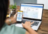 Digital ID Fight Goes Global Person using online banking on laptop and smartphone.