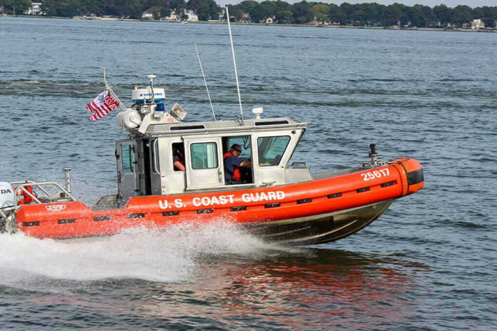1750211480-1 Coast Guard boat speeding on the water.