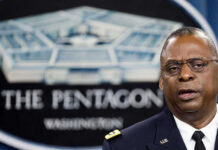 Iran Attack Claim Raises Questions Amid Tensions Man speaking in front of Pentagon sign.