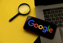 Magnifying glass, laptop, and smartphone displaying Googles logo.