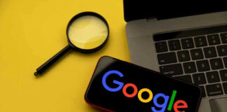 Magnifying glass, laptop, and smartphone displaying Googles logo.