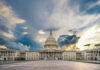 U.S. Capitol building with dramatic cloudy sky.