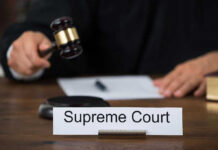 Supreme Court Case Could Redefine Birthright Citizenship Judge with gavel and Supreme Court nameplate.
