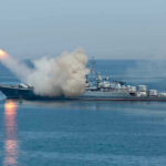 Iran Attack Kills Civilian, Disrupts Kuwait Airport Warship firing missile in the sea.