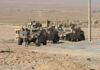 Beaufort Grab Sparks New Gaza Fears Soldiers beside military vehicles in a desert area.