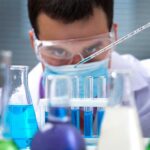Warning in Pipes, No Patients Found Scientist conducting an experiment with blue liquids in a laboratory
