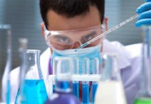 Warning in Pipes, No Patients Found Scientist conducting an experiment with blue liquids in a laboratory