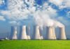 Record Heat Pushes Europe to the Breaking Point Nuclear power plant with cooling towers emitting steam against a blue sky