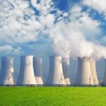 Record Heat Pushes Europe to the Breaking Point Nuclear power plant with cooling towers emitting steam against a blue sky
