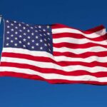 The Freedom Trucks Changing How America Teaches History Waving American flag against a clear blue sky