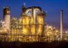 Mystery Deepens After Fatal Aramco Helicopter Crash An industrial facility with illuminated structures at night