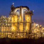 Mystery Deepens After Fatal Aramco Helicopter Crash An industrial facility with illuminated structures at night