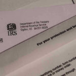 IRS letters and envelopes on a table.