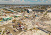 Coast Guard Says Seven Rescued After Barge Collision Aerial view of hurricane-damaged buildings and debris.