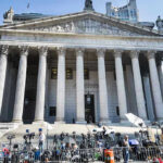 Surveillance Footage and Forensic Disputes Fuel Debate Courthouse facade with media crews setting up outside.