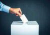 Texas Senate Race Explodes Into a National Fight Hand placing ballot into voting box.