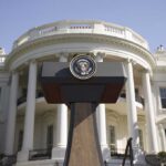 White House Hands UFO Role to Harvard Scientist Press podium with presidential seal in front of the White House