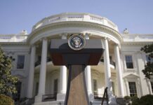 White House Hands UFO Role to Harvard Scientist Press podium with presidential seal in front of the White House