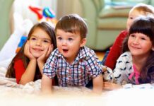 California Proposal to Affirm Black English Revives Ebonics Debate A group of children enjoying playtime indoors, displaying joyful expressions