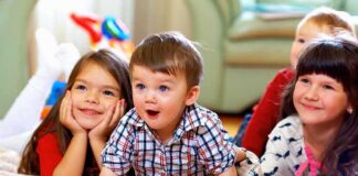 A group of children enjoying playtime indoors, displaying joyful expressions