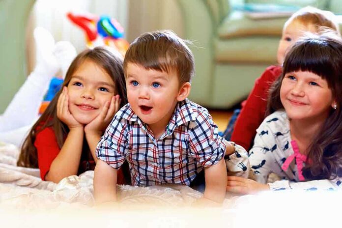 shutterstock_125877587 A group of children enjoying playtime indoors, displaying joyful expressions