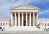 Woman Restriction: Supreme Court Weighs Fairness Front view of the Supreme Court building with large columns and steps under a blue sky