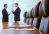 OpenAI’s No. 2 Steps Back Over Health Two business professionals engaged in conversation in a conference room