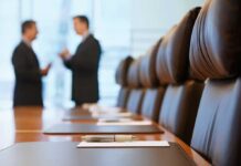 OpenAI’s No. 2 Steps Back Over Health Two business professionals engaged in conversation in a conference room