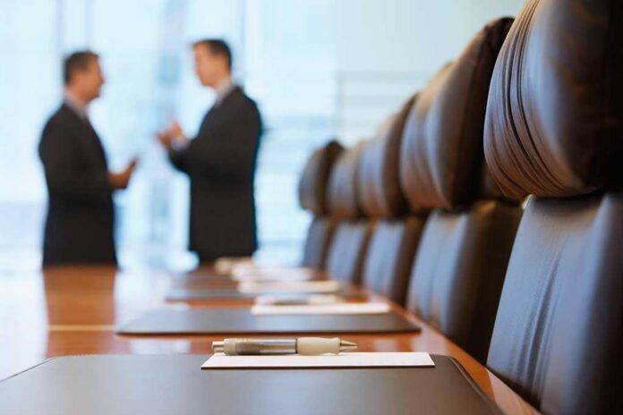 Two business professionals engaged in conversation in a conference room
