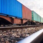 Freight train with colorful shipping containers on railway tracks