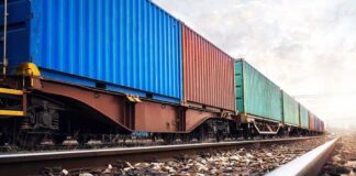 Freight train with colorful shipping containers on railway tracks