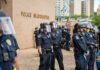 Terror Bombshell: State Department Targets Far-Left Groups Police officers in riot gear stand in formation outside a headquarters building