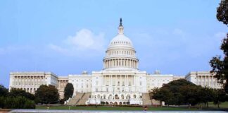 View of the U.S. Capitol building with a security barrier in front