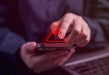 Security Blunder Exposes Hollywood Contact Records Person tapping smartphone with red warning icon