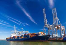 From Belt and Road to Strategic Strongpoints Container ship docked at port with cranes loading cargo