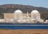 Satellite Photos Raise Questions About Success of U.S. Iran Strikes Nuclear power plant with domed structures beside a water body and mountains in the background