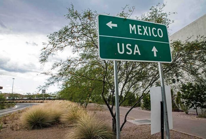 shutterstock_486345745-2-1- Road sign indicating directions to Mexico and the USA