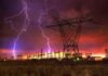 Cyberattacks, Sabotage, and Storms Threaten the Grid Lightning strikes illuminate a power station against a colorful sunset sky