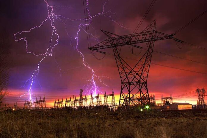 Lightning strikes illuminate a power station against a colorful sunset sky
