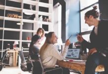 Coworkers collaborating at a desk in a modern office