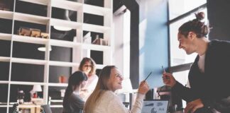 Coworkers collaborating at a desk in a modern office