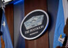 Claim Emerges: Nuclear Talks Over Iran The Pentagon emblem between two flags.