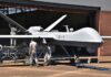 The U.S. Is Building Its Next Air Dominance Fighter Military drone being serviced by ground crew outside a hangar