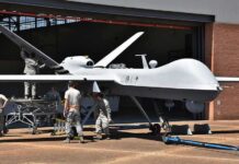 The U.S. Is Building Its Next Air Dominance Fighter Military drone being serviced by ground crew outside a hangar