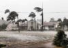 Houses battered by hurricane winds and flooding