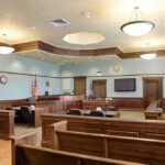 Jury Faces Difficult Question Over Mother’s Mental State Empty courtroom with wooden benches and judge's bench