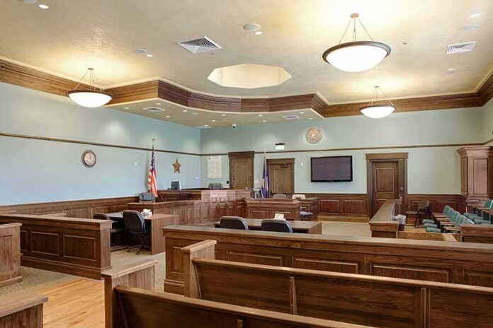 shutterstock_1349439551 Empty courtroom with wooden benches and judge's bench