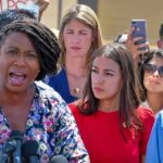 Owner Explodes: WNBA Co-Owner Faces Suspension Speaker addressing crowd at outdoor press event