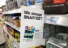Shelf sign in a grocery aisle showing SNAP EBT acceptance